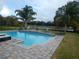 Inviting pool with a fire pit, lounge chairs, and a view of the lake at 915 Ekana Green Ct, Oviedo, FL 32765