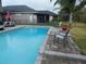 Backyard pool with a paved patio and lush green lawn at 915 Ekana Green Ct, Oviedo, FL 32765