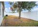 Backyard with a flowering tree, AC unit, and a white vinyl fence at 10421 Andover Point Cir, Orlando, FL 32825
