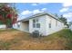 Exterior view of a house with a backyard and an AC unit at 10421 Andover Point Cir, Orlando, FL 32825