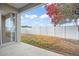 Covered patio, white vinyl fence, and a flowering tree in the backyard at 10421 Andover Point Cir, Orlando, FL 32825