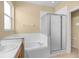Primary bathroom with dual sinks, a soaking tub, and a separate shower at 10421 Andover Point Cir, Orlando, FL 32825