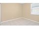 Empty bedroom with neutral-colored walls, tiled flooring, and a window with blinds at 10421 Andover Point Cir, Orlando, FL 32825