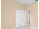 Bedroom with neutral walls, tile flooring, and a double closet at 10421 Andover Point Cir, Orlando, FL 32825