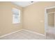 Empty bedroom with neutral walls, tiled floors, and window with blinds at 10421 Andover Point Cir, Orlando, FL 32825