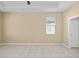 Spacious bedroom with tile flooring, ceiling fan, and ample natural light at 10421 Andover Point Cir, Orlando, FL 32825
