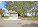 Front exterior of a single-story home with a two-car garage and landscaping at 10421 Andover Point Cir, Orlando, FL 32825