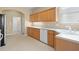 Kitchen with oak cabinetry, white appliances, and tile floor at 10421 Andover Point Cir, Orlando, FL 32825