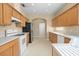Spacious kitchen with oak cabinets, white appliances, and tile flooring at 10421 Andover Point Cir, Orlando, FL 32825