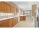 Kitchen with oak cabinets, white appliances, and breakfast bar at 10421 Andover Point Cir, Orlando, FL 32825
