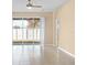 Spacious living room with tile flooring, ceiling fan, and sliding glass doors to backyard at 10421 Andover Point Cir, Orlando, FL 32825