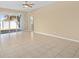 Living room with sliding glass door, ceiling fan and tile flooring at 10421 Andover Point Cir, Orlando, FL 32825