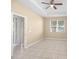 Living room with tile flooring, ceiling fan, and access to a patio at 10421 Andover Point Cir, Orlando, FL 32825