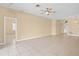 Large living room with tile floors, ceiling fan, and doorways to adjacent rooms at 10421 Andover Point Cir, Orlando, FL 32825