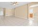Open living area with tile flooring, ceiling fan, and view towards kitchen at 10421 Andover Point Cir, Orlando, FL 32825