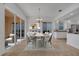 Dining room with sliding glass doors, white kitchen cabinets, and modern light fixture at 11840 Eagle Ray Lane, Orlando, FL 32827