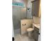 Modern bathroom with walk-in shower and gray shaker cabinets at 12143 Grand Oak Ln, Oxford, FL 34484