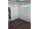 Bedroom with wood-look flooring and access to a bathroom at 12143 Grand Oak Ln, Oxford, FL 34484
