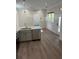 Open concept kitchen and living area with wood-look flooring at 12143 Grand Oak Ln, Oxford, FL 34484