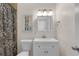 Clean and bright bathroom with white vanity, toilet, and patterned shower curtain at 1363 Whitewood Dr, Deltona, FL 32725