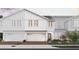 Modern two-story home with white siding, two-car garage, and landscaped yard at 160 Glass Onion Dr, Groveland, FL 34737
