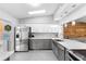 Modern kitchen with white and gray cabinets, stainless steel appliances, and white marble countertops at 2112 Staunton Ave, Winter Park, FL 32789