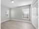 Well-lit bedroom with wood-look floors and window at 2436 Princeton Ave, Sanford, FL 32771