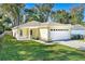 Yellow house exterior with a white garage door and porch at 2436 Princeton Ave, Sanford, FL 32771