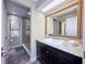 Bathroom with vanity, granite counter, shower, and large mirror at 3100 Parkway Blvd # 110, Kissimmee, FL 34747
