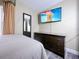 Bedroom featuring a wall-mounted TV, dresser, and comfortable bed at 3100 Parkway Blvd # 110, Kissimmee, FL 34747