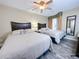 Bedroom with two beds, ceiling fan, and wood-look tile flooring at 3100 Parkway Blvd # 110, Kissimmee, FL 34747