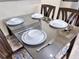 Dining table set for four with modern place settings at 3100 Parkway Blvd # 110, Kissimmee, FL 34747