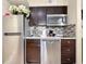 Well-equipped kitchen with stainless steel appliances and dark wood cabinetry at 3100 Parkway Blvd # 110, Kissimmee, FL 34747
