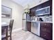 Modern kitchen with stainless steel appliances and dining area at 3100 Parkway Blvd # 110, Kissimmee, FL 34747