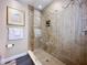 Spacious shower with tile surround, glass door, and recessed shelving at 3100 Parkway Blvd # 110, Kissimmee, FL 34747