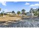 Large backyard with a basketball hoop, shed, and palm trees at 3292 Sw 133Rd Lane Rd, Ocala, FL 34473