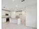 Bright white kitchen with stainless steel appliances and an island at 3318 Thicket St, Tavares, FL 32778