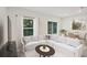 Living room with white sectional sofa, coffee table, and dining area at 3318 Thicket St, Tavares, FL 32778