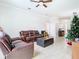 Living area featuring a brown leather sectional sofa and ottoman at 430 Dagama Dr, Clermont, FL 34715