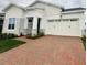 Two-story home with stone accents and a brick driveway at 5015 Dancy Ln, St Cloud, FL 34772