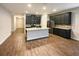 Kitchen with island, stainless steel appliances, and dark gray cabinets at 6414 Flat Lemon Dr, Winter Garden, FL 34787