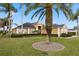 Home with a tile roof, palm trees, and landscaped yard at 715 Sanctuary Dr, Oviedo, FL 32766