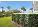 Backyard with lush green lawn, a privacy hedge, and a white fence at 7770 Sandy Ridge Dr # 114, Reunion, FL 34747