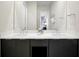 Double vanity with white countertop, dark cabinets, and a large mirror in the bathroom at 7770 Sandy Ridge Dr # 114, Reunion, FL 34747