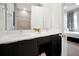 Contemporary bathroom featuring double sinks, dark wood cabinets, and a large mirror at 7770 Sandy Ridge Dr # 114, Reunion, FL 34747