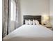 Comfortable bed with white linens in a well-lit bedroom at 7770 Sandy Ridge Dr # 114, Reunion, FL 34747