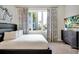 Second bedroom with a comfortable bed, large window, and modern decor at 7770 Sandy Ridge Dr # 114, Reunion, FL 34747