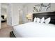 Modern bedroom with a comfortable bed, stylish nightstands, and access to another room at 7770 Sandy Ridge Dr # 114, Reunion, FL 34747