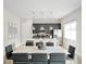 Open-concept dining area with a marble table, seating for eight, and views of the kitchen at 7770 Sandy Ridge Dr # 114, Reunion, FL 34747
