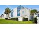 Modern townhome exterior with blue and gray siding, fenced yard, and landscaping at 7770 Sandy Ridge Dr # 114, Reunion, FL 34747